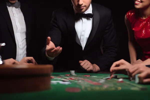 A glowing roulette wheel with cascading chips, symbolizing the engaging live and instant-win games available on TKPKK.